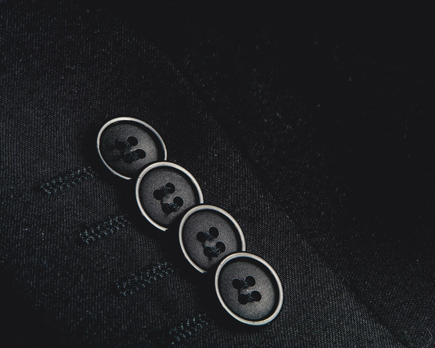 Close view of fine suit cloth and hand-finished buttons